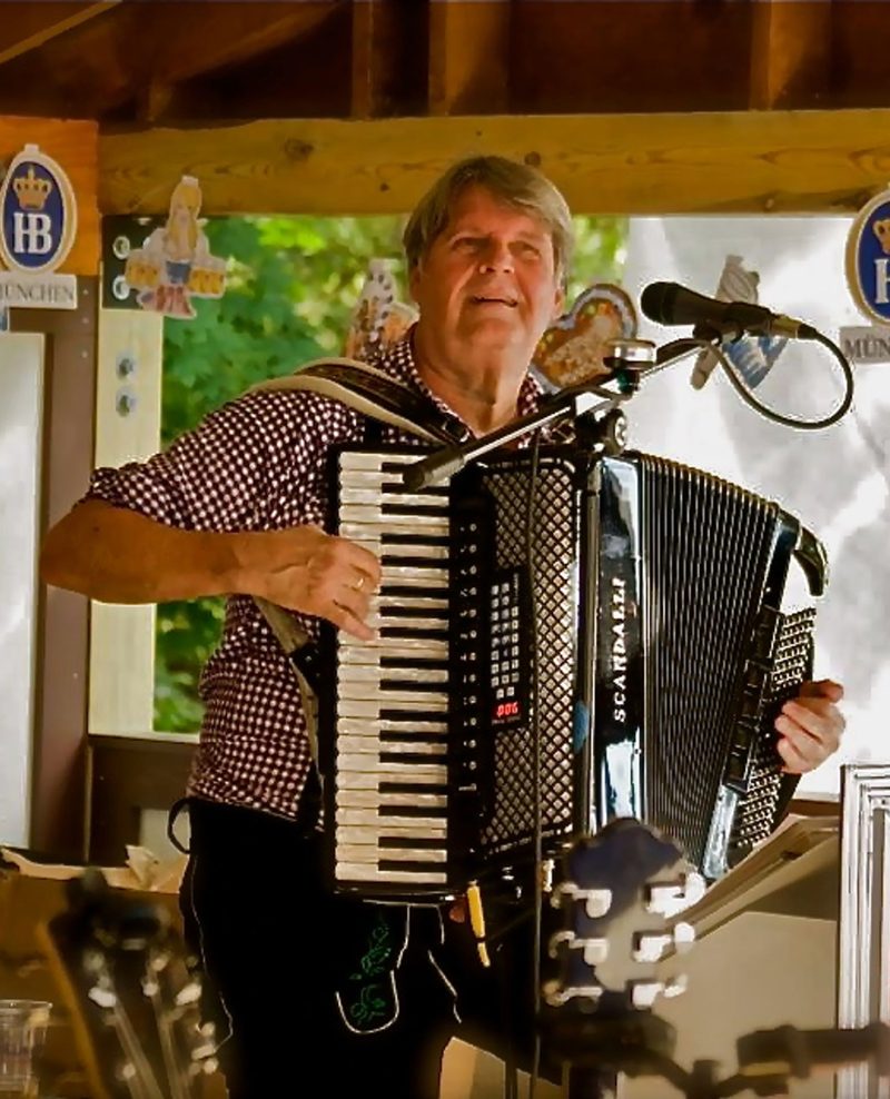 Accordion player performing under the tent